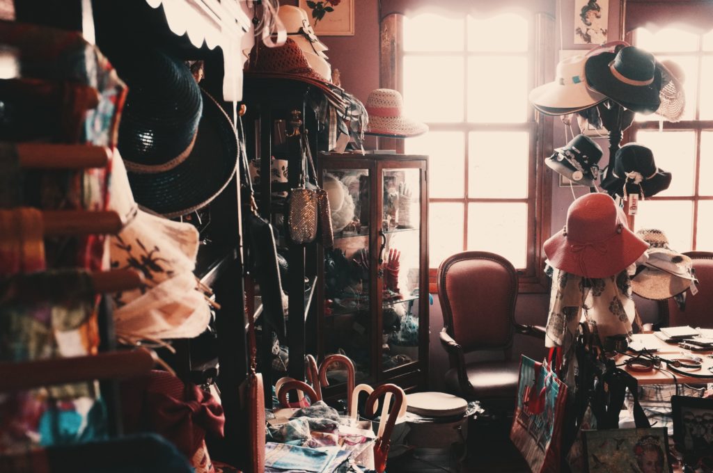 Cluttered room with clothing and hats