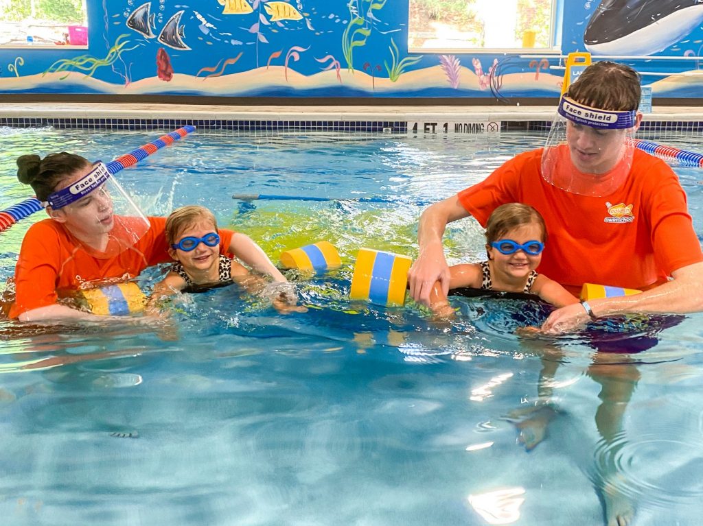 Goldfish Swim School instructors guide swimmers at their Roswell, GA location