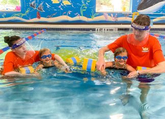 Goldfish Swim School instructors guide swimmers at their Roswell, GA location